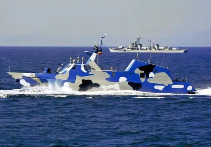 Type 022 Houbei fast attack catamaran at speed in blue camouflage