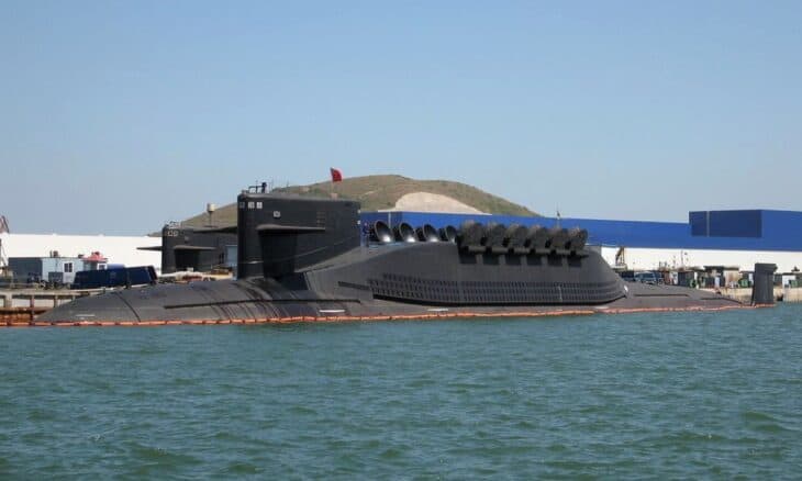 Type 094 Jin-class ballistic missile submarine pierside with its missile hump visible
