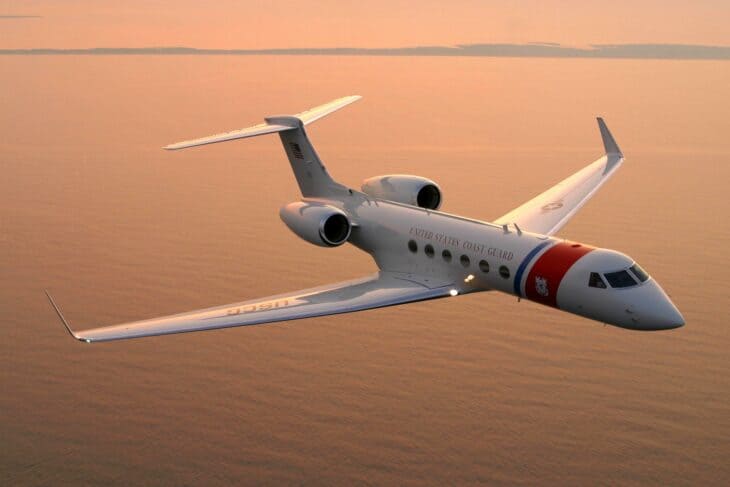 Coast Guard C-37A Gulfstream in flight at sunset