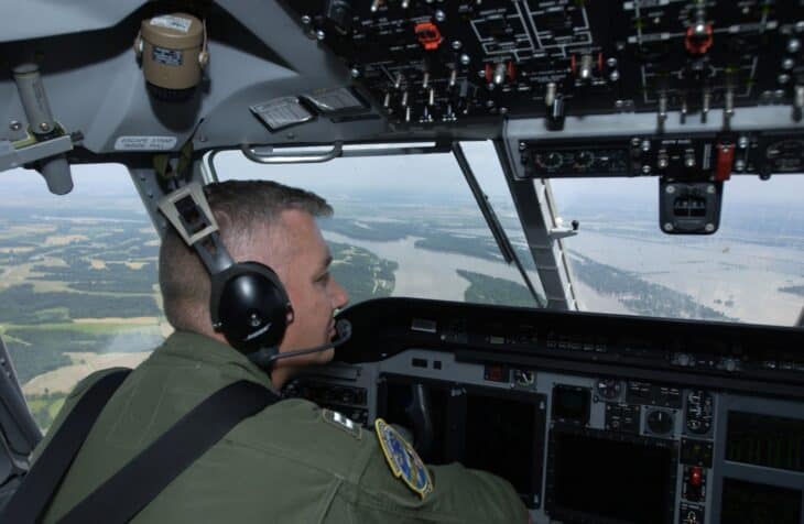 Coast Guard pilot at the controls in the glass cockpit of an HC-144 Ocean Sentry