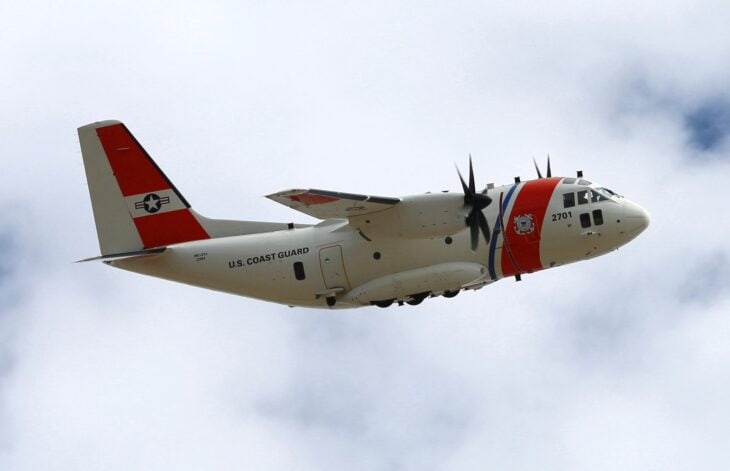 Coast Guard HC-27J Spartan in flight with red and blue stripes