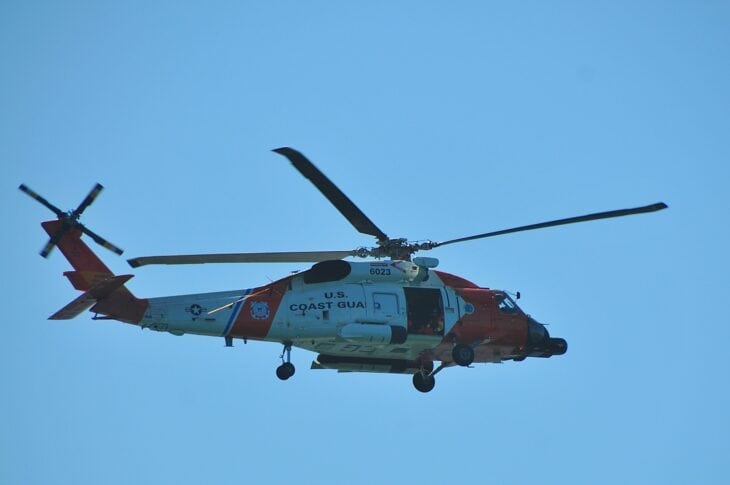 Coast Guard MH-60T Jayhawk in flight against a blue sky
