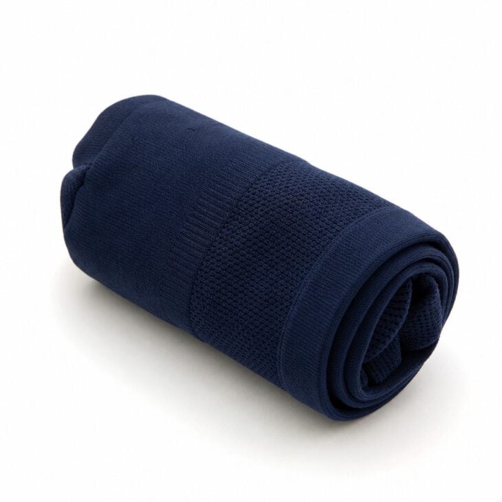 Rolled navy compression socks on a white background