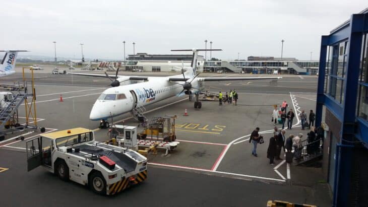 Turboprop airliner and ground vehicles on the apron at Glasgow Airport
