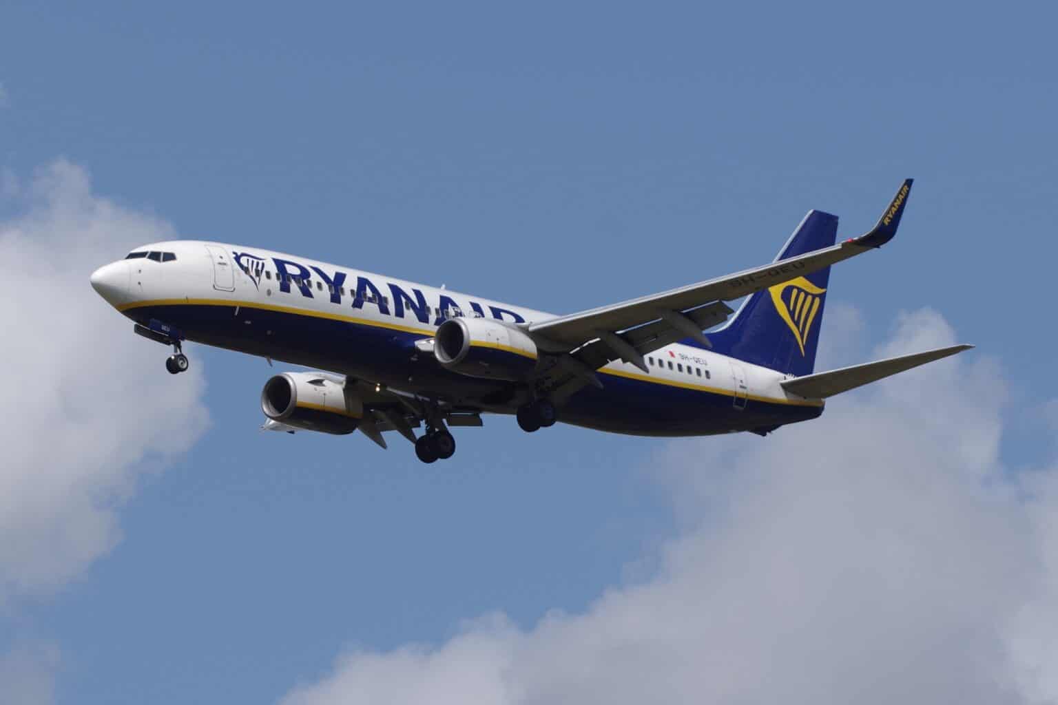 Ryanair-liveried Boeing 737-800 9H-QEU on approach with gear down against a blue sky