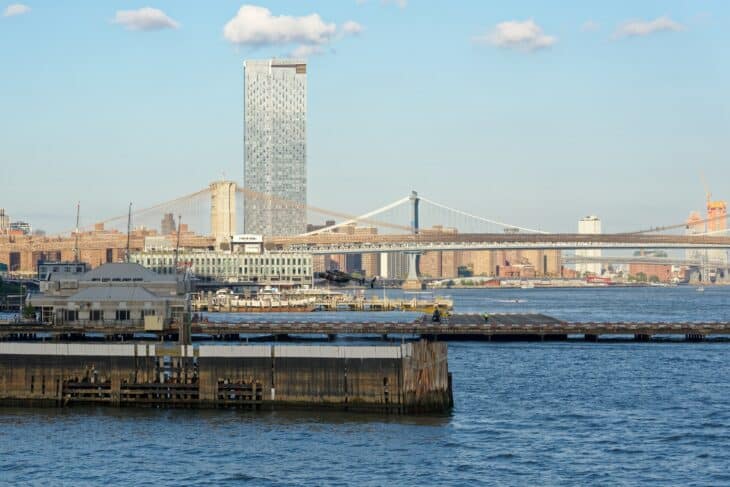 The Downtown Manhattan Heliport pier on the East River with the Brooklyn and Manhattan bridges behind it