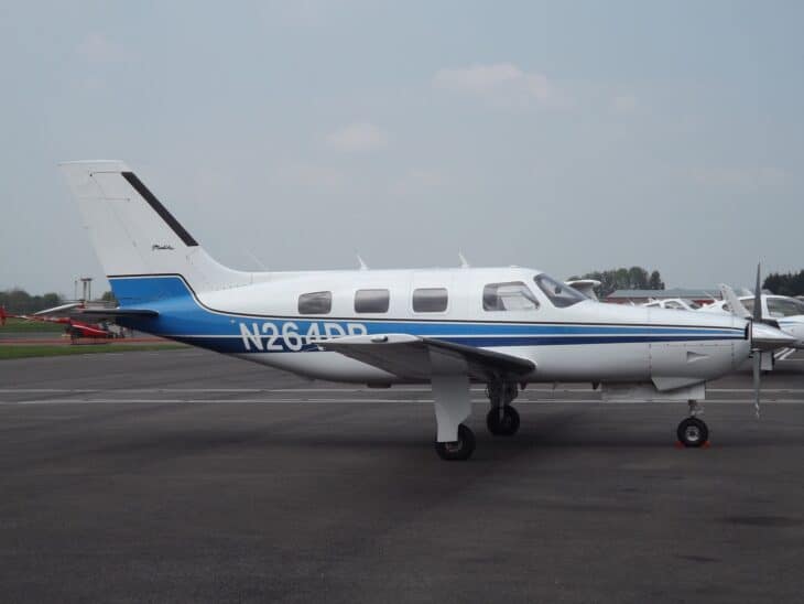 Piper PA-46-310P Malibu N264DB parked on an apron in its white and blue livery