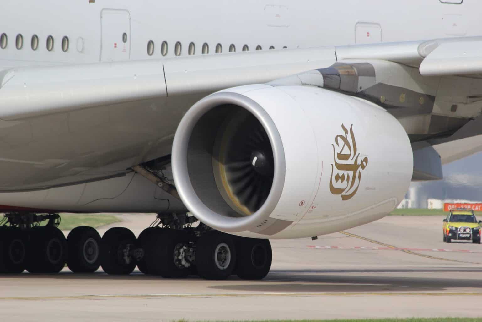 Engine Alliance GP7270 engine with Emirates titles on Airbus A380-861 A6-EDS, fan spinning, above the main landing gear at Manchester Airport