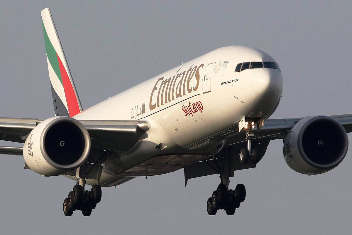 Emirates SkyCargo Boeing 777F A6-EFO on final approach with its landing gear extended, seen nose-on