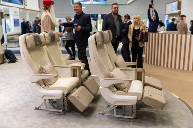 Emirates premium economy seats with deep recline and leg rests on display at a trade fair