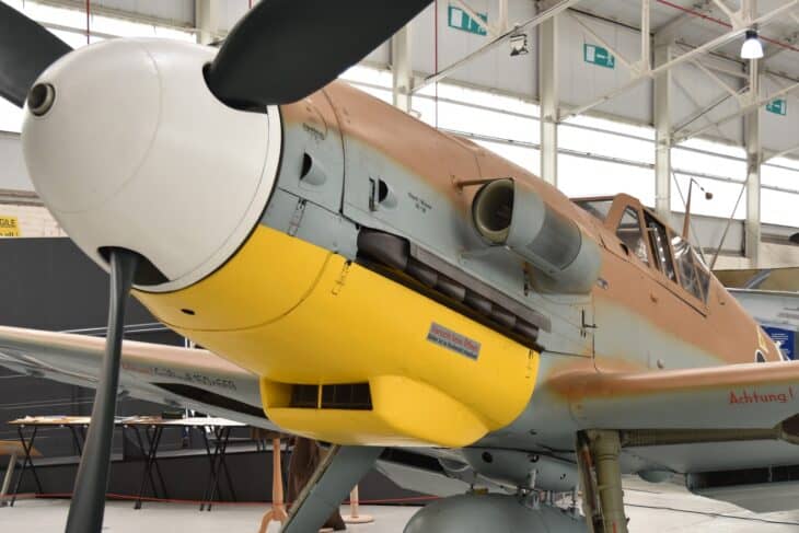 Nose-on view of a Messerschmitt Bf 109G-6 Trop with yellow cowling in a museum hangar