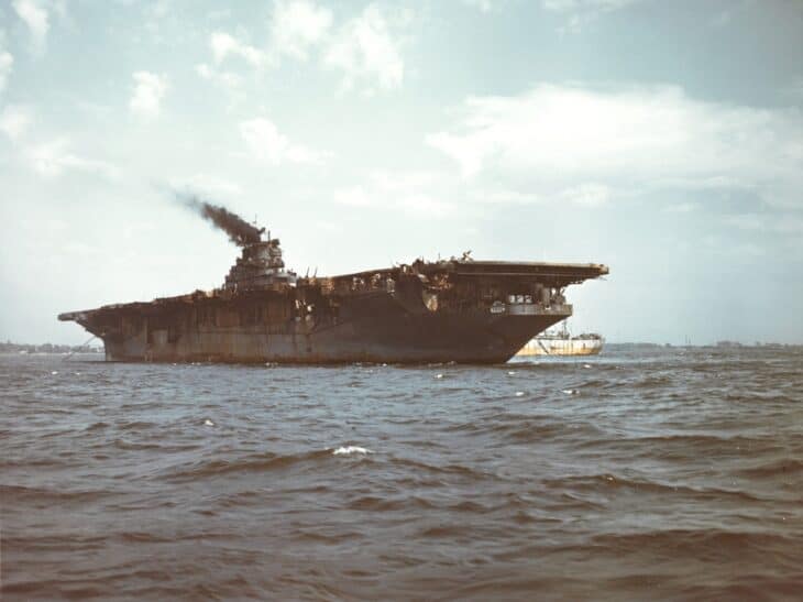 Burned-out USS Franklin (CV-13) at anchor off New York with smoke still rising after the March 1945 bomb hit