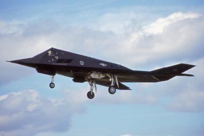 F-117A Nighthawk 86-0823 on approach with landing gear down against a cloudy sky