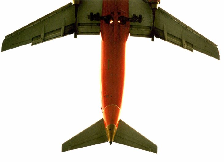 Underside of a Southwest Airlines Boeing 737 in flight, showing the aft fuselage, wings and horizontal stabilizers