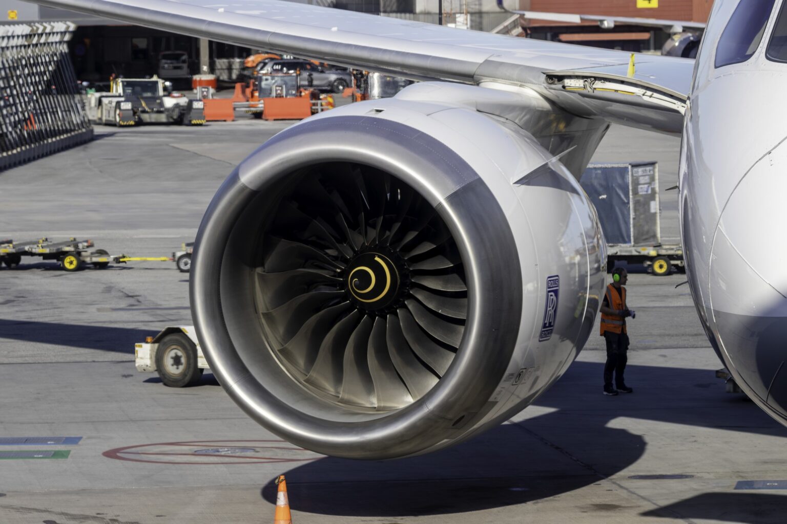 Head-on view of a Rolls-Royce Trent 1000 engine fan on an ANA Boeing 787 parked at the gate