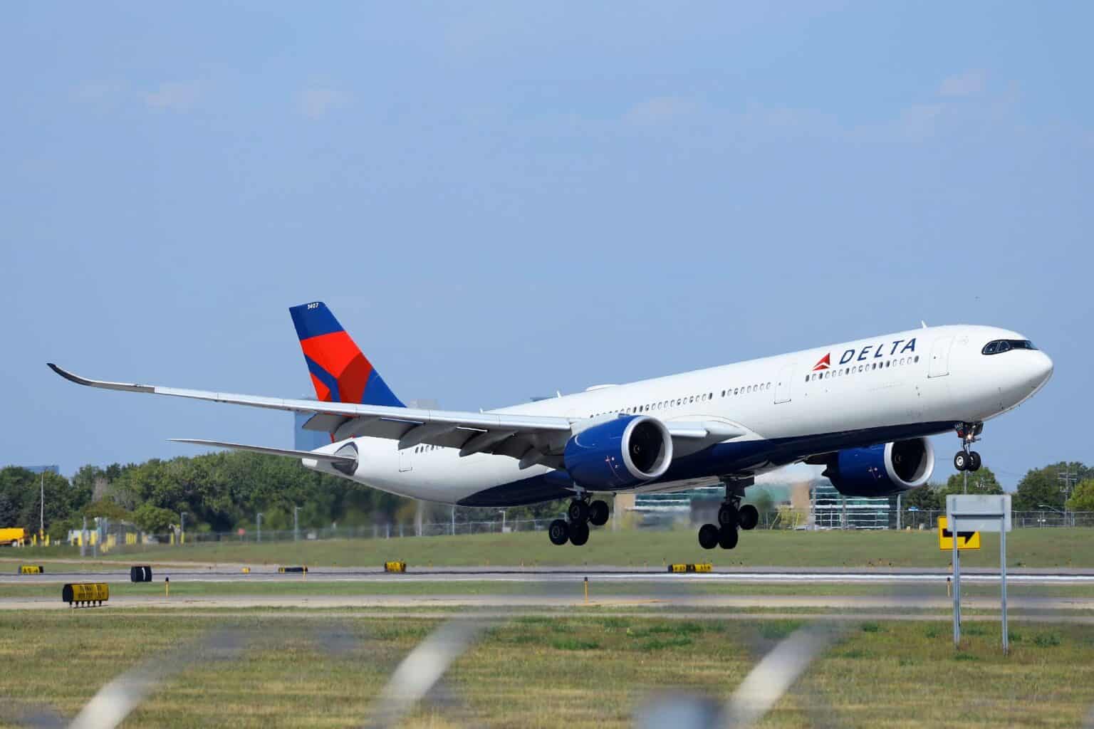 Delta Air Lines Airbus A330-900 N407DX touching down on a runway with its main gear just meeting the pavement