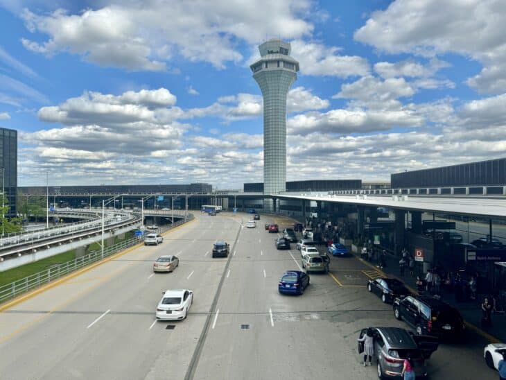 Chicago O'Hare air traffic control tower rising above the airport's terminals and roadway