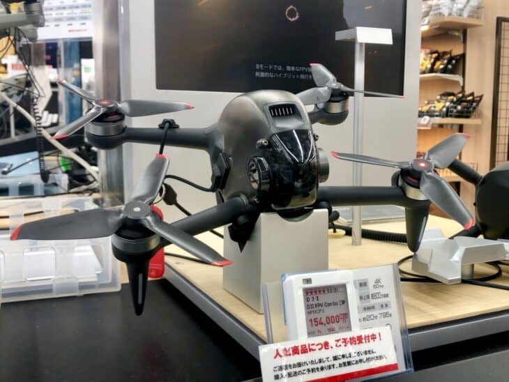 DJI FPV drone on display at a Japanese electronics store, seen from the front quarter
