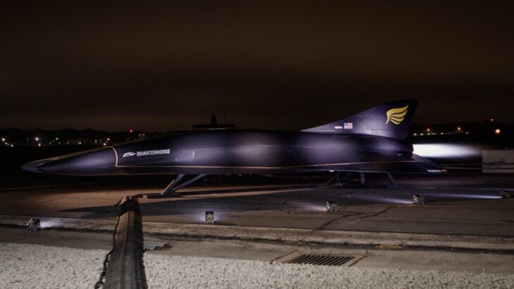 Hermeus Quarterhorse prototype lit up on the ramp at night during its unveiling