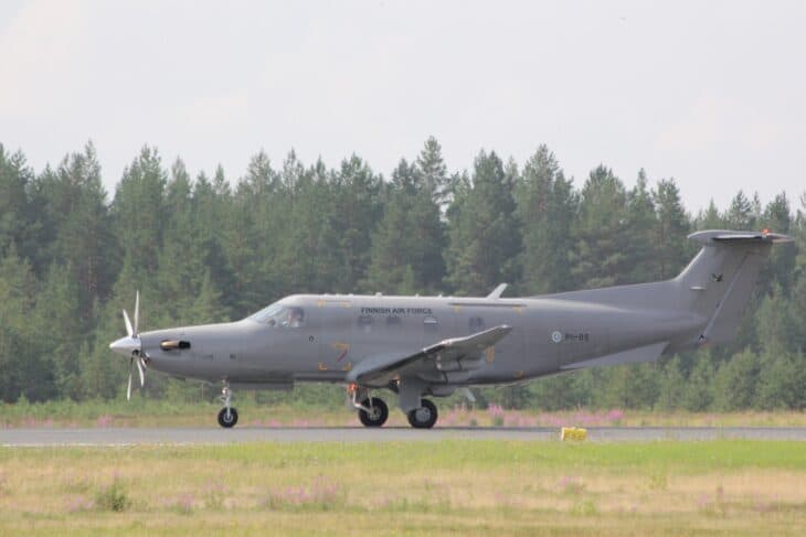 Finnish Air Force Pilatus PC-12 PI-05 rolling along a grass-edged runway in front of a pine forest