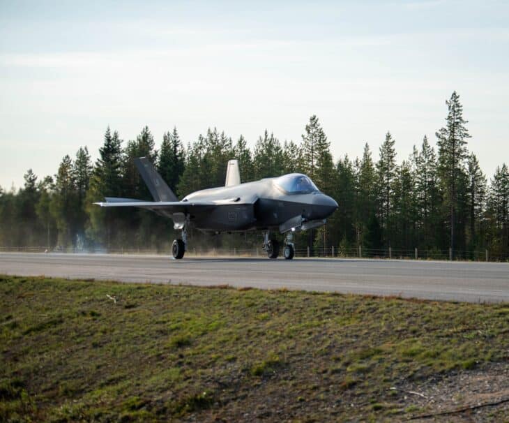 A US Air Force F-35A rolling out on a Finnish highway strip lined with pine forest