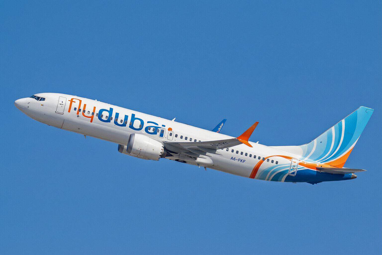 Flydubai Boeing 737 MAX 8 A6-FKF climbing out against a clear blue sky