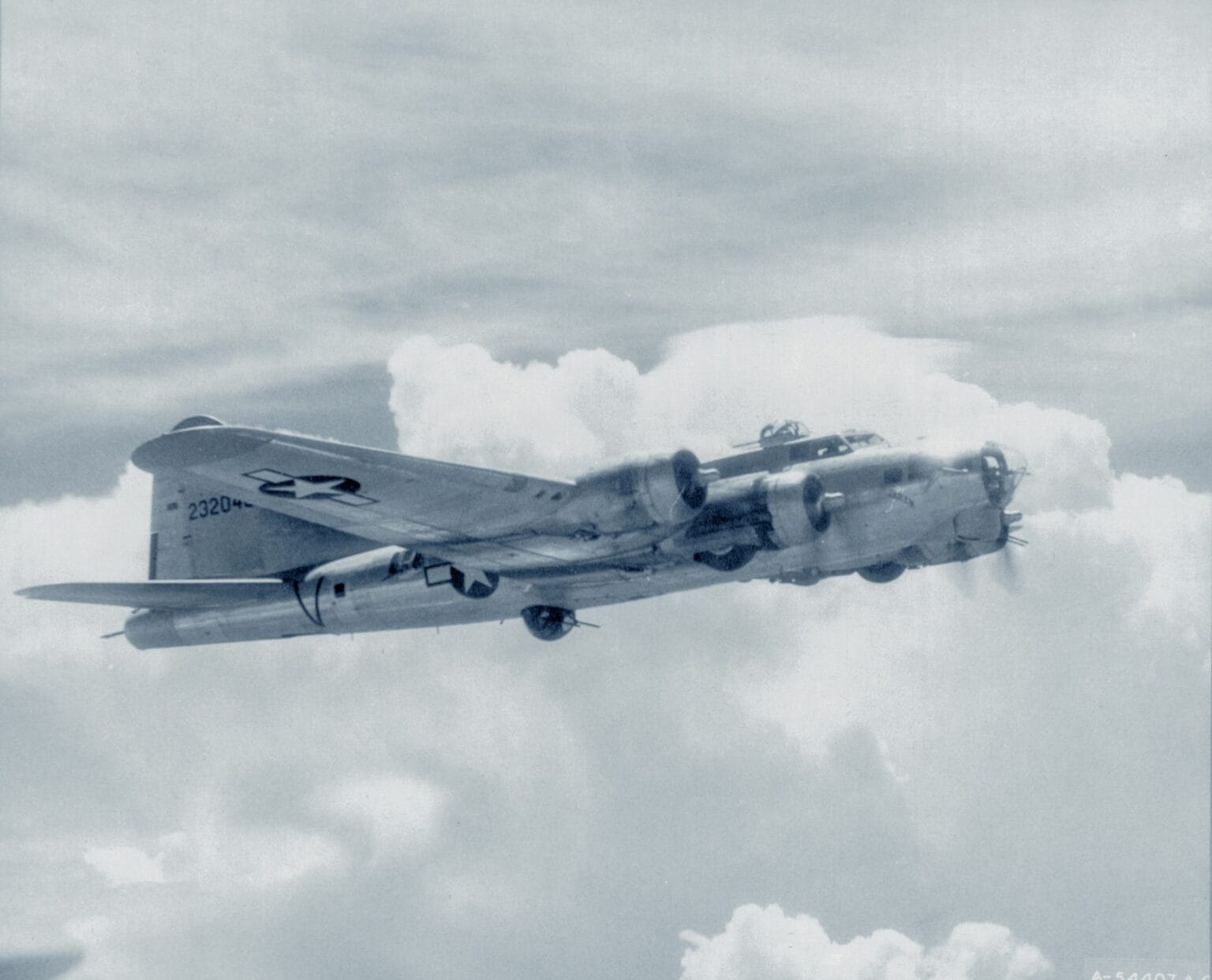 USAAF B-17G Flying Fortress of the 15th Air Force flying among towering clouds in a wartime photograph