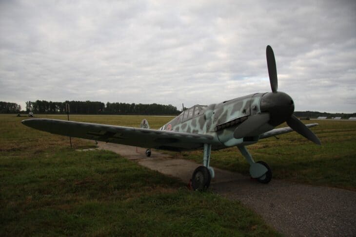Messerschmitt Bf 109G-6 parked on grass with a propeller and mottled grey-green camouflage