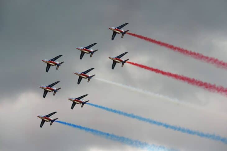 Patrouille de France Alpha Jets in formation trailing blue, white and red smoke