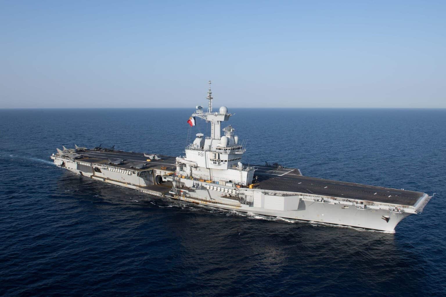 French aircraft carrier Charles de Gaulle underway at sea seen from above, flight deck and island visible