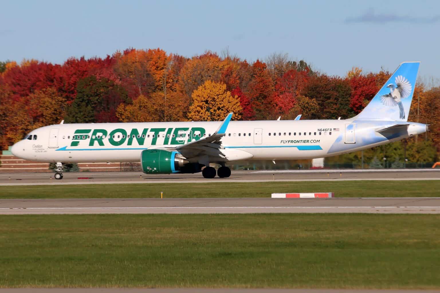 Frontier Airlines Airbus A321neo N646FR on the runway at Cleveland Hopkins, with autumn trees in red and orange behind it