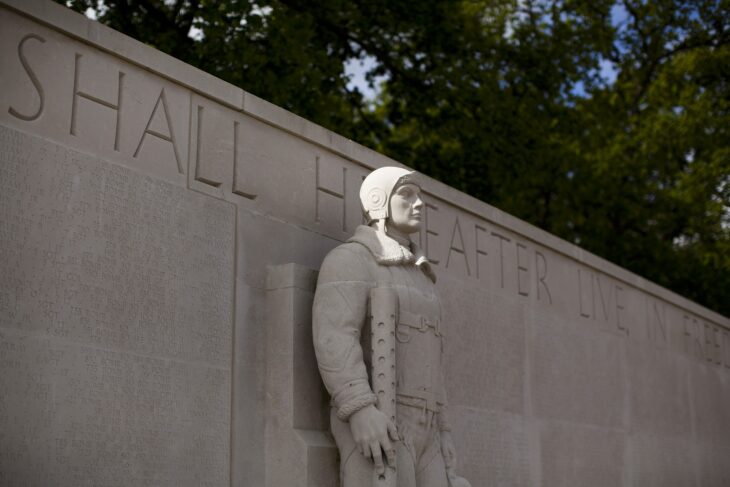 Statue of an airman on the Tablets of the Missing wall at Cambridge American Cemetery