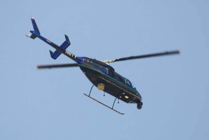 Bell 206L-4 LongRanger IV N6TY in flight with its main rotor turning against a blue sky
