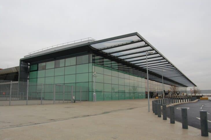 Glass-fronted building of Heathrow Terminal 4 under a grey sky