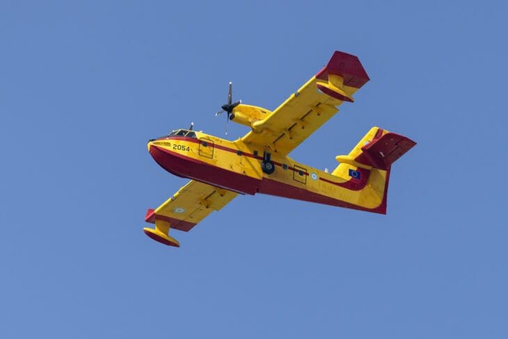 Hellenic Air Force Canadair CL-415 in yellow and red firefighting livery banking in flight