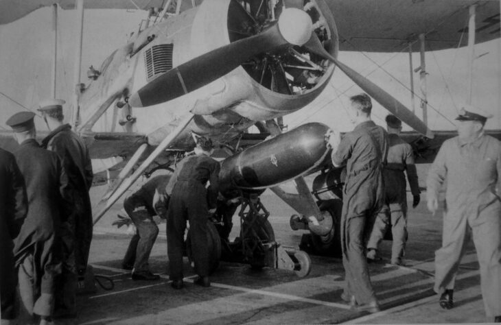 Armourers loading a torpedo onto a Fairey Swordfish on the deck of HMS Ark Royal (91) in 1941