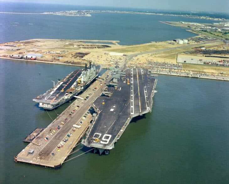 Aerial view of HMS Ark Royal (R09) berthed beside the American carrier USS Nimitz at Norfolk in 1978