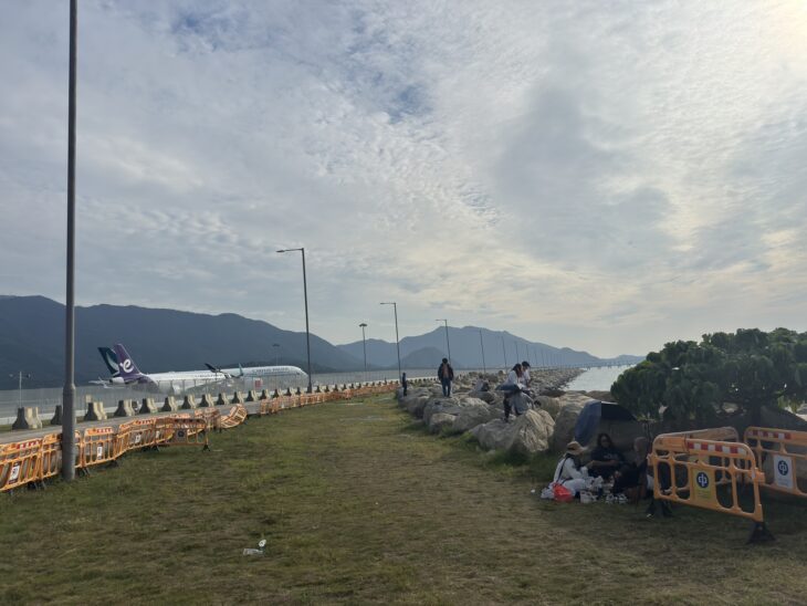 Shoreline rocks and safety barriers beside the aircraft maintenance area at Hong Kong International Airport