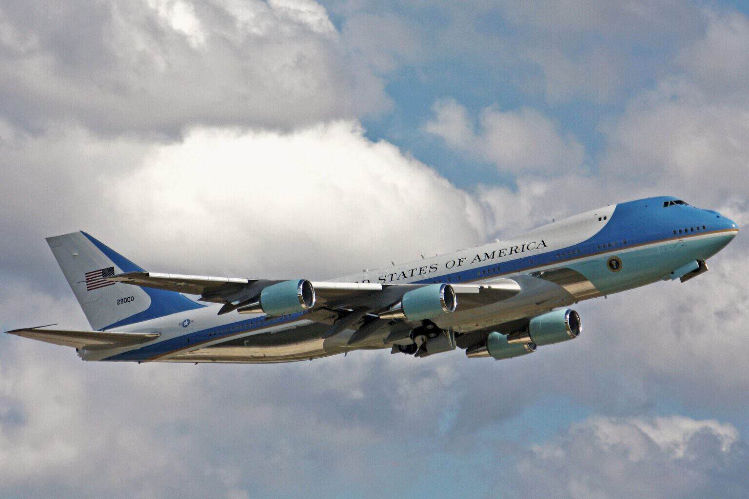 Air Force One VC-25A tail 29000 climbing out of Cleveland Hopkins with its gear retracted against a cloudy sky