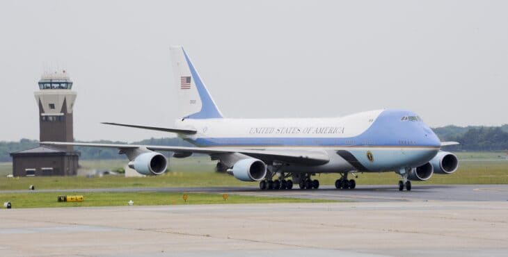 Air Force One VC-25A taxiing past a control tower at Joint Base McGuire-Dix-Lakehurst