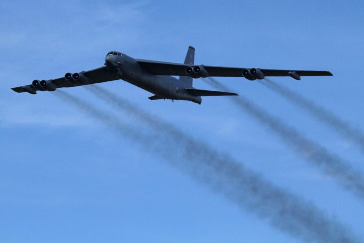 Boeing B-52H Stratofortress in flight with contrails streaming from its eight engines