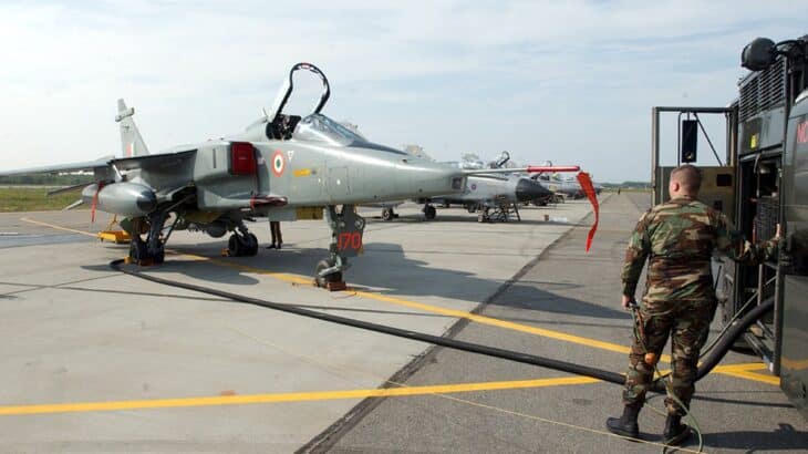 Indian Air Force Jaguar on the ramp while a crew member refuels it
