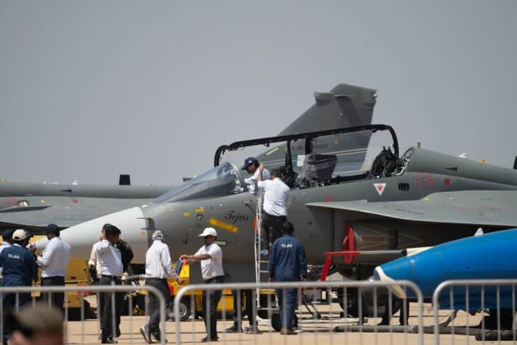 HAL Tejas fighter at a static display with a crowd behind the barrier
