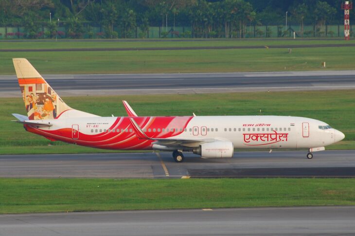 Air India Express Boeing 737-800 VT-AXI taxiing past grass