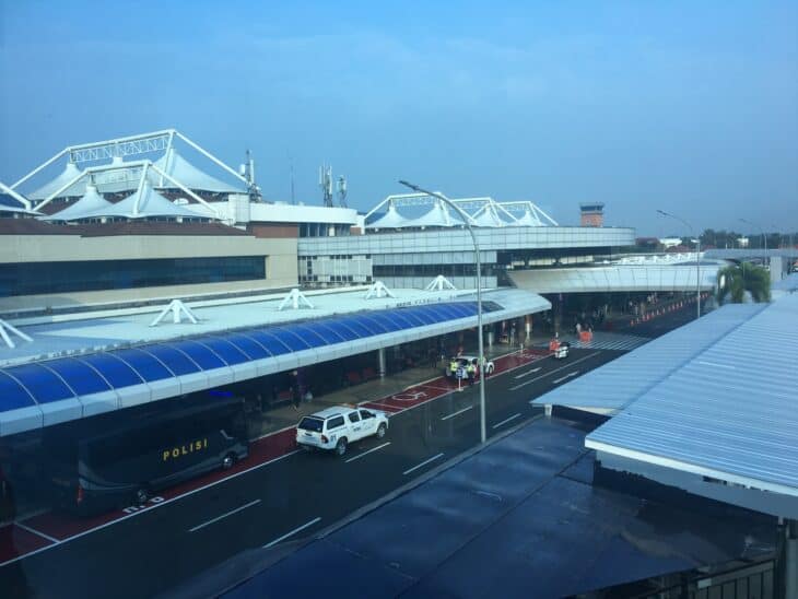 Front of the terminal at Sultan Mahmud Badaruddin II Airport in Palembang under a hazy sky