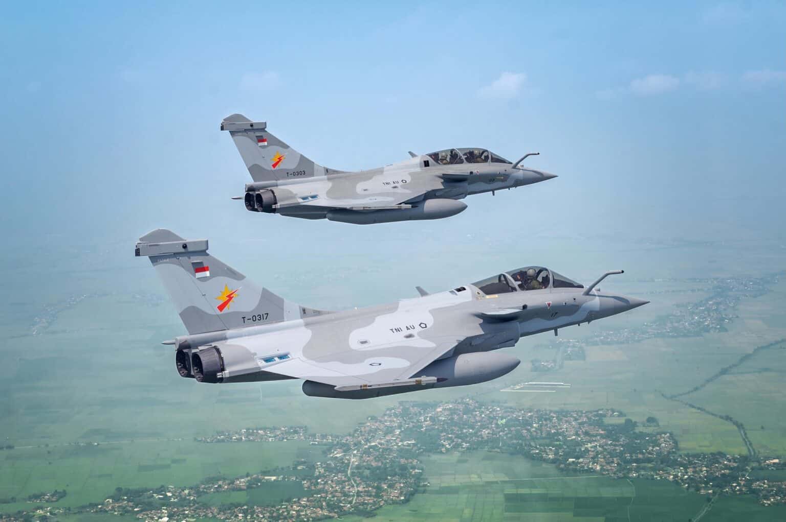 Two Indonesian Air Force Dassault Rafales flying over farmland in Indonesia