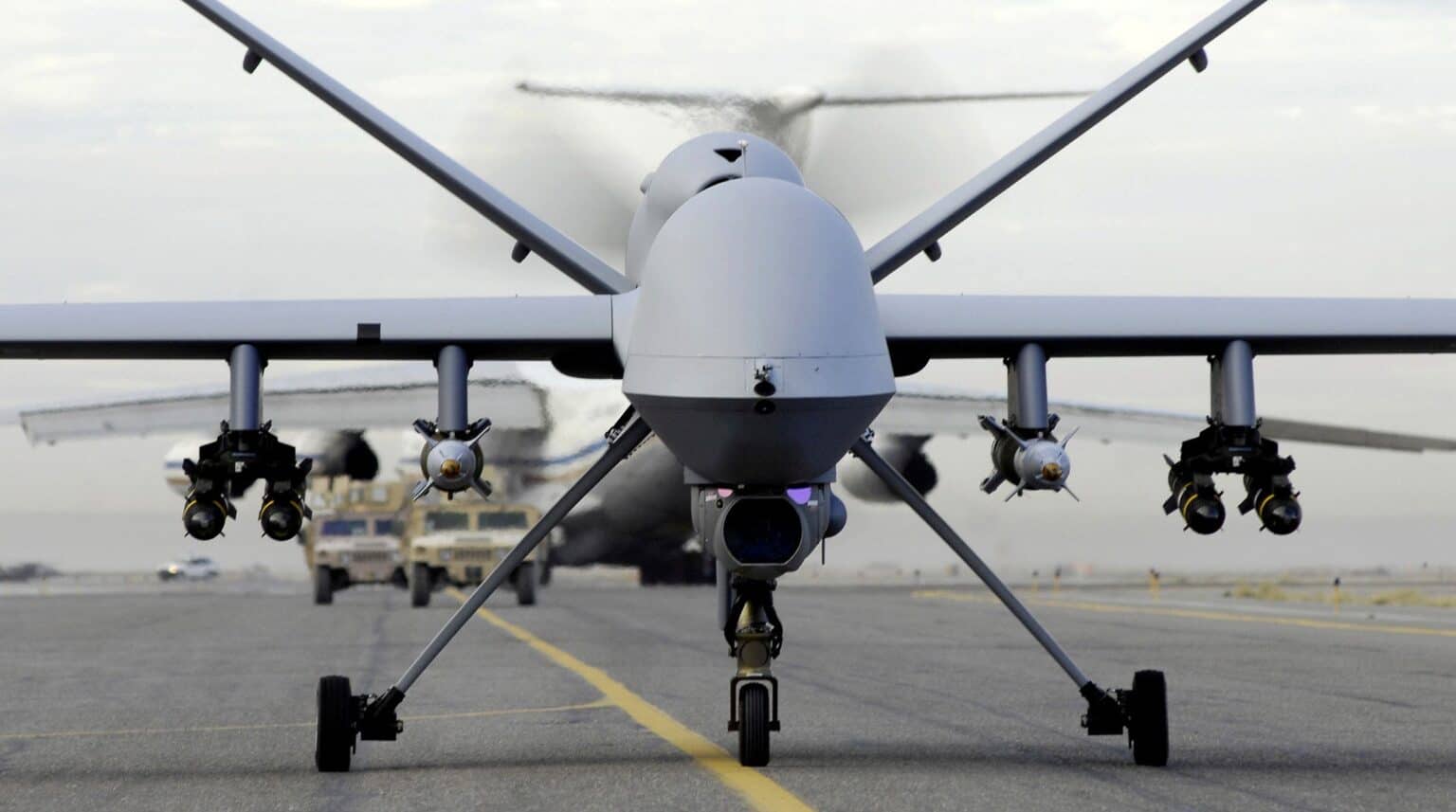 Head-on view of a US Air Force MQ-9 Reaper on a taxiway with Hellfire missiles and laser-guided bombs under its wings