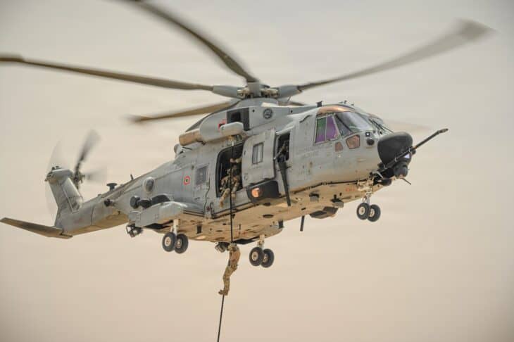 Italian Air Force HH-101A helicopter hovering during fast-rope training