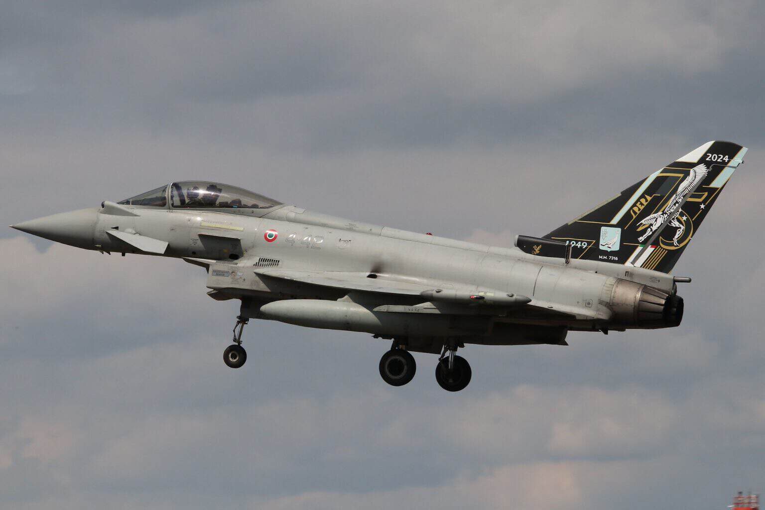 Italian Air Force Eurofighter Typhoon MM7316 in flight with landing gear down and a commemorative tail scheme