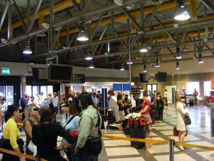 Passengers queuing at the check-in area of Florence airport